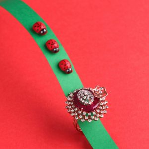 Artistic jewelry photography featuring a luxurious diamond and ruby ring on a vibrant red and green background.
